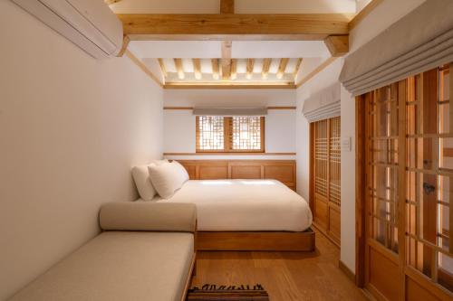 a bedroom with two beds and a window at Luxury Hanok On169 in Seoul