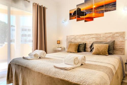 a bedroom with a bed with towels on it at Villa Orange with private pool Albufeira in Albufeira