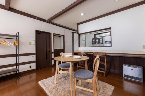 a dining room with a table and two chairs at Irest Village Matsumoto 2 in Matsumoto