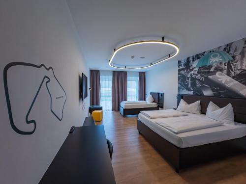 a living room with a bed and a couch at RINGRAST Boxenstopp mit HERZ in Spielberg