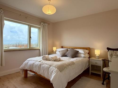 a bedroom with a bed with two towels on it at Cottage 498 - Cleggan in Cleggan