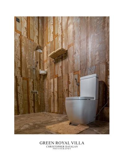 a bathroom with a white toilet in a room at Green Royal Villa in Kandy