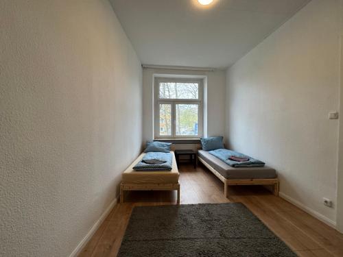 a room with two beds and a window at Platin Appartement in Wuppertal