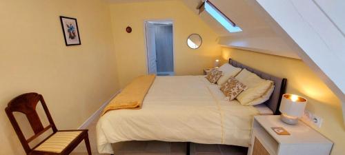 a bedroom with a bed and a desk with a chair at Le Verger Chambres d'hotes in Ségur-le-Château