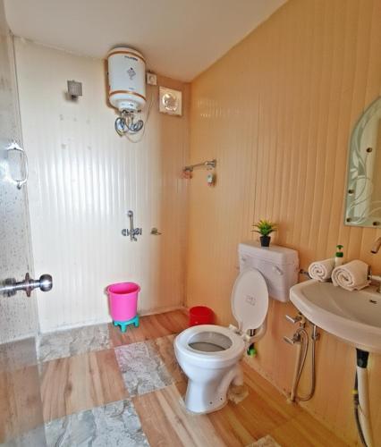 a bathroom with a toilet and a sink at 7 Hills Resort Kanatal in Kanatal