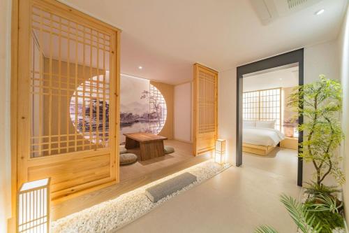 a room with a bedroom with a bed and a door at Yeonhwamoon Hotel Yangyang in Yangyang