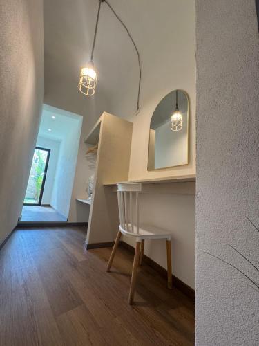 a room with a table and a chair and lights at Bella Gallery Terrasini in Terrasini