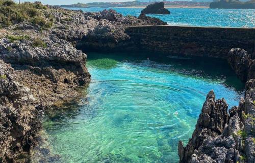 a pool of water in the middle of a rocky beach at Casa PREGONDA in Isla