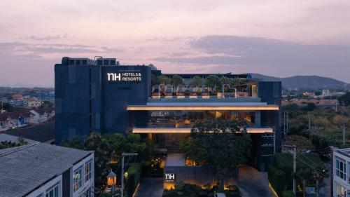 a building with a sign on the side of it at NH Hua Hin in Hua Hin