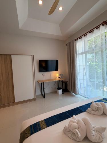 a bedroom with a bed with towels on it at Kata Kata Stay in Kata Beach