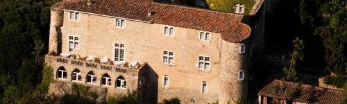 a large brick building on top of a mountain at Château de Madières - Châteauzen in Rogues