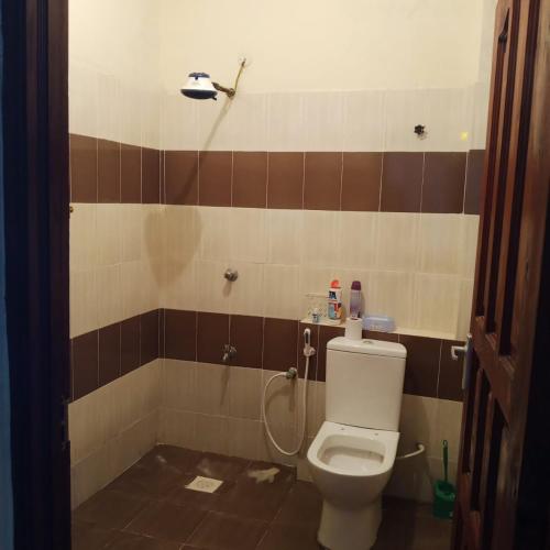 a bathroom with a toilet and a shower at Bamburi Mombasa Three bedrooms at Cutraz homes apartments 010 in Mtwapa