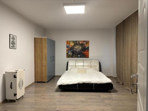 a bedroom with a bed and a painting on the wall at Bob Residence- Chic Penthouse in Cluj-Napoca
