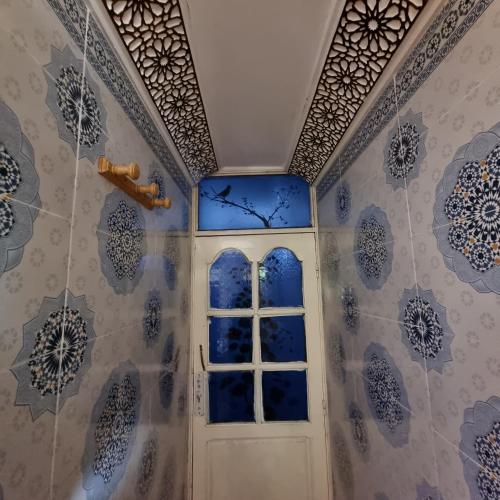a door in a room with blue and white tiles at Momo's villa in Aït Ourir