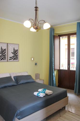 a bedroom with a bed with towels on it at SudOceania Apartment in Lamezia Terme