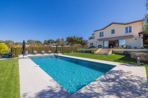 a swimming pool in the backyard of a villa at REF 2193 - Super Cannes Villa for rent in Vallauris