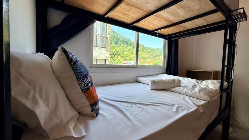 a bedroom with a bunk bed with a window at DANK Hotel 420 friendly Patong Phuket in Patong Beach