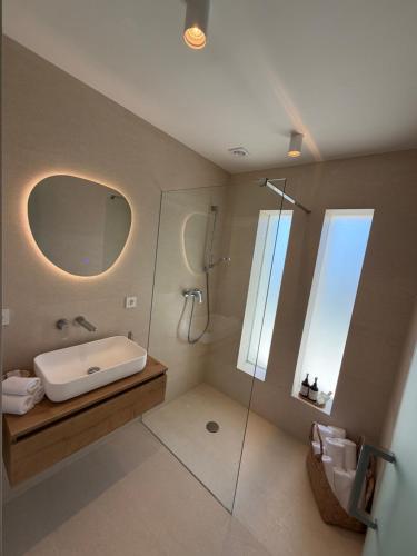 a bathroom with a shower and a sink and a mirror at Villa Čapula - Modern Apartment with Sea View and Parking, Marušići in Omiš