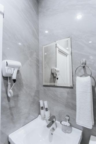 a bathroom with a sink and a mirror at Classic Hotel Samarkand in Samarkand