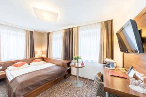 Postel nebo postele na pokoji v ubytování Austria Classic Hotel Hölle