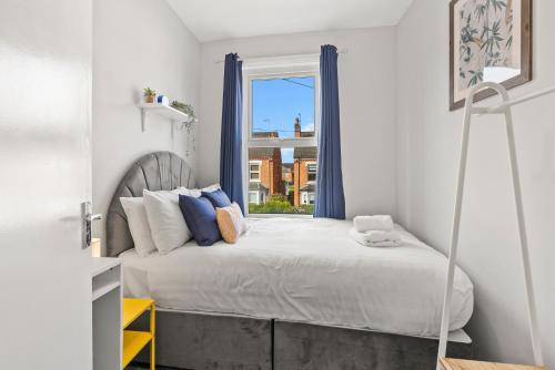 a bedroom with a large bed with a window at 5-Bed Family & Group Stay Near Cricket Ground in Worcester