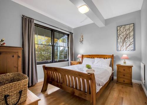 a bedroom with a bed and a large window at River Verse in Porepunkah
