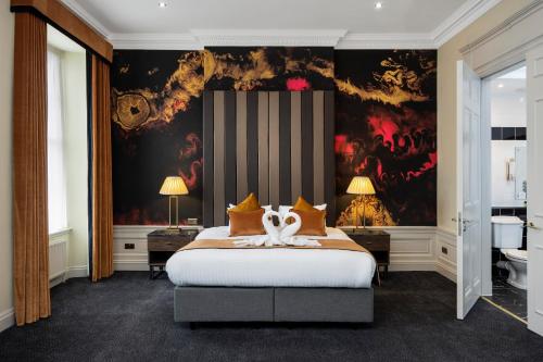 a bedroom with a large bed with a painting on the wall at Albany Hotel in Edinburgh
