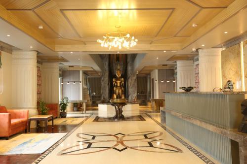 a lobby with a chandelier in the middle of a building at PRAGATI MANOR in Guwahati