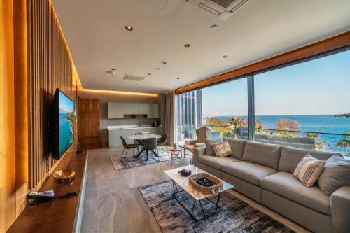 a living room with a couch and a view of the ocean at Arts Hotel Bodrum Yalikavak in Yalıkavak