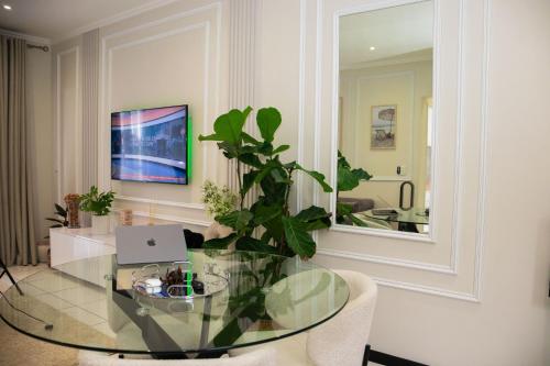 a dining room with a glass table and a mirror at Luxury Sunset Gem with Power Backup in Sandton