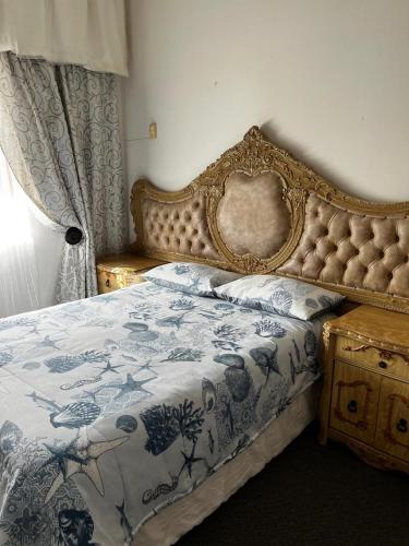 a bedroom with a bed with a blue and white blanket at Let Us accommodation in East London