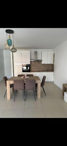 a kitchen with a wooden table and chairs in a room at MaVi Apartament in Castel di Sangro