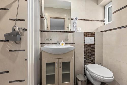 a small bathroom with a sink and a toilet at Penzion Na Chalupě in Polička