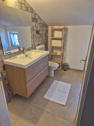 a bathroom with a sink and a toilet at Appartment Štajon in Izola