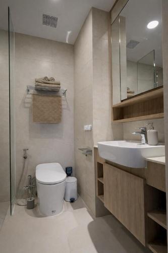 a bathroom with a toilet and a sink at Skypark Celeste with stunning golf course view in Laguna Phuket