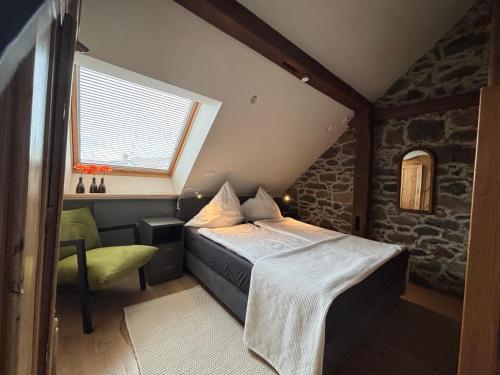a small bedroom with a bed and a window at Historische Ferienwohnung mit Sauna und Dachterrasse in Lich