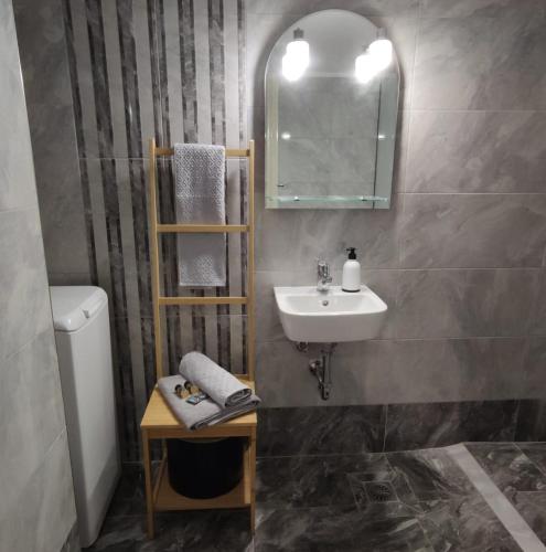 a bathroom with a sink and a toilet and a mirror at Cozy City Apartment - sleeps 2 in Rhodes Town