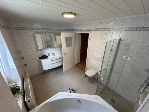 a bathroom with a tub and a toilet and a sink at Ferienhaus-Saale-Unstrut in Wethau