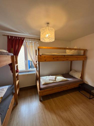 a room with two bunk beds and a chandelier at Ferienhaus-Saale-Unstrut in Wethau