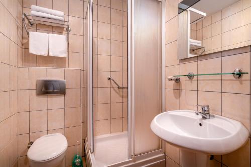a bathroom with a toilet and a sink and a shower at Ozlem Garden Hotel in Side