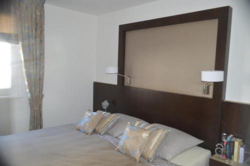 a bedroom with a bed with a large wooden headboard at Ferienwohnung Gesine 2 in Nienhagen