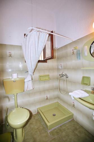 a bathroom with a toilet and a sink at Kastri in Panormos Skopelos