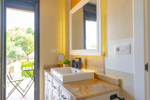 a bathroom with a sink and a window at Lar de Sefa 15 in Redondela
