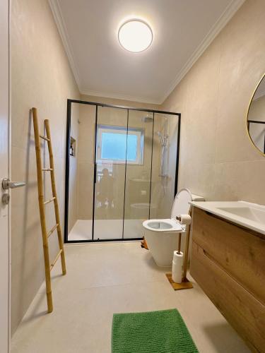 a bathroom with a shower and a toilet and a sink at Bay Golf House in Cascais