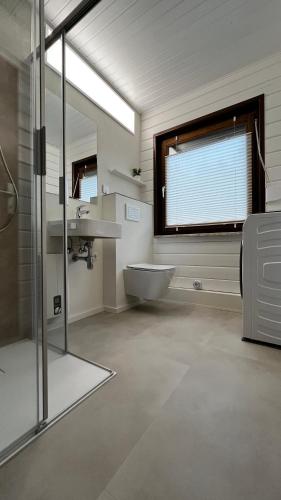 a bathroom with a tub and a sink and a window at Ferienhaus Waldliebe in Grafenau