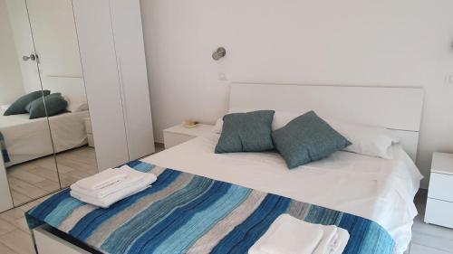 a bedroom with a bed with towels on it at CasAmare in Montesilvano