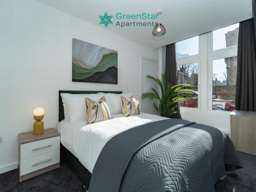 a bedroom with a bed and a window at GreenStar Apartments - Short Walk Away Into Dundee City Centre - 6 Individual Properties from 1 to 3 Bedrooms - Short & Long Stay Offers! in Dundee