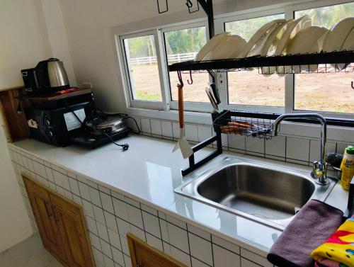 a kitchen with a sink and a counter top at Lamae Beachfront Villa in Ban Laem No
