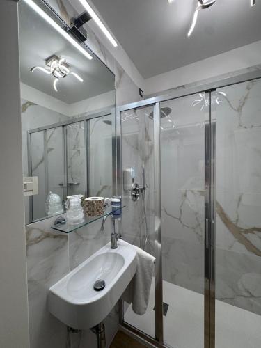 a bathroom with a sink and a shower at Hotel Adriatico in Venice
