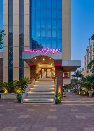 a building with stairs in front of a building at Hotel Studio Estique in Pune